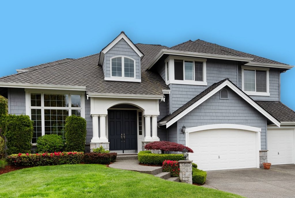 Wide shot of blue home with green lawn