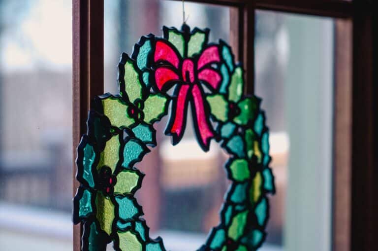 stained glass holiday wreath decor in window